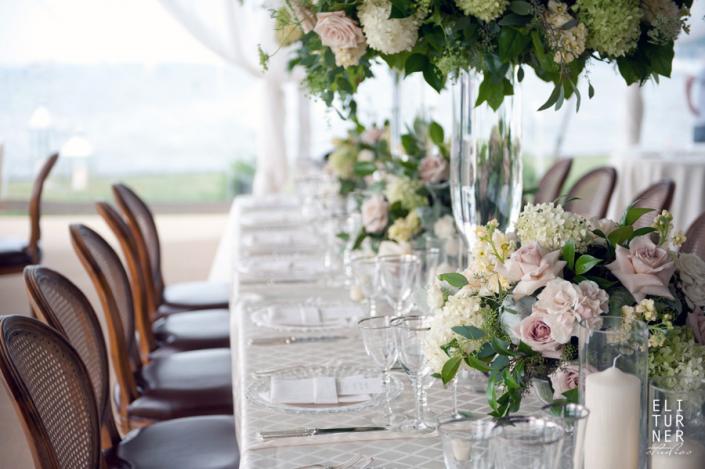 Beautiful, soft bouquets line this table with roses, hydrangea and lush greenery.