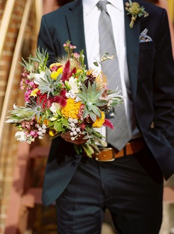 This unique bridal bouquet looks as if it was just picked from the garden, succulents designed within a wild flower bouquet.