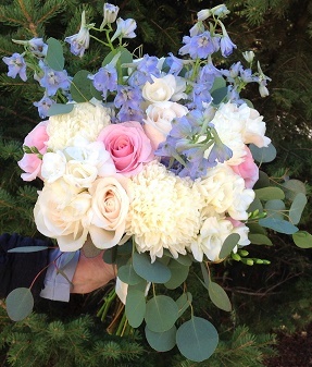  Light blue delphinium, standard mums, roses, freesia and seeded eucalyptus.