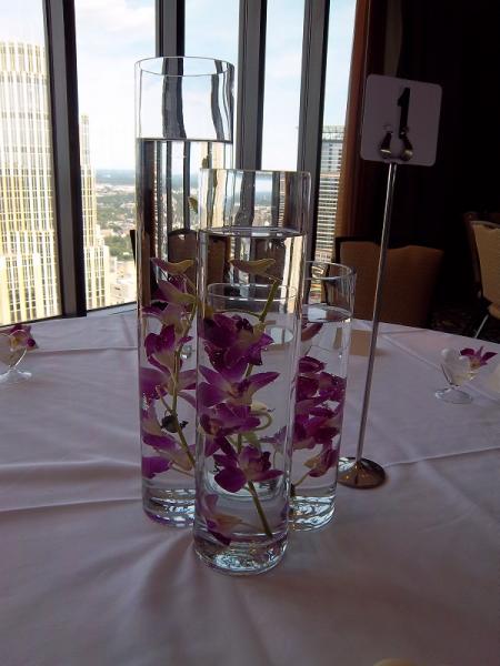  This centerpiece can be designed with a variety of fresh flowers suspended in the water and accented with a floating candle.