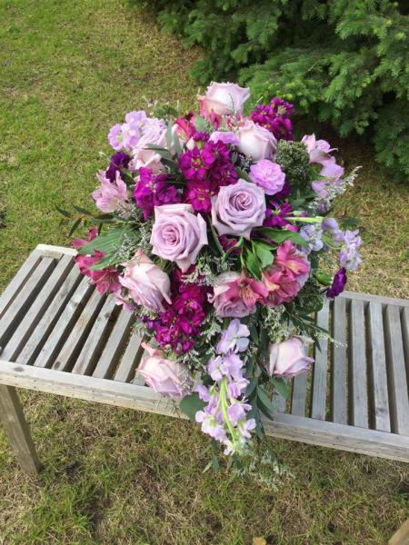 Garden look of purple roses, lavender and fushia stock. pink alstromeria and purple trachillium.