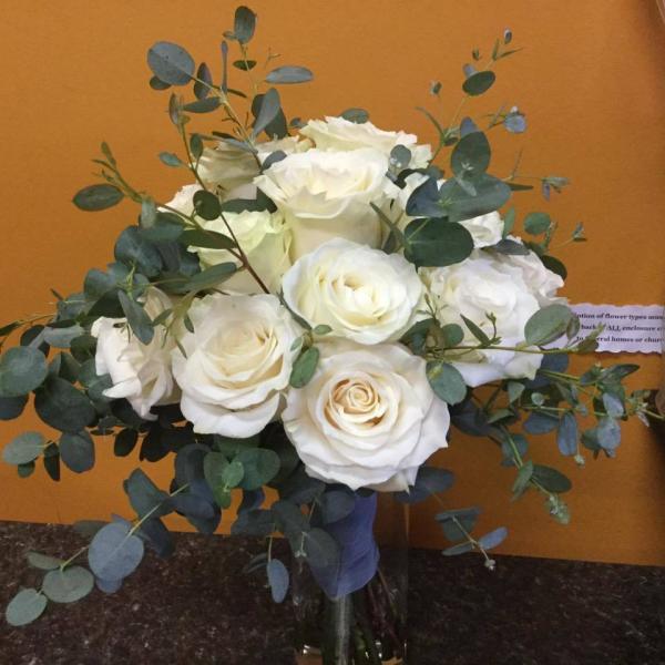 Beautiful white roses with a variety of eucalyptus.