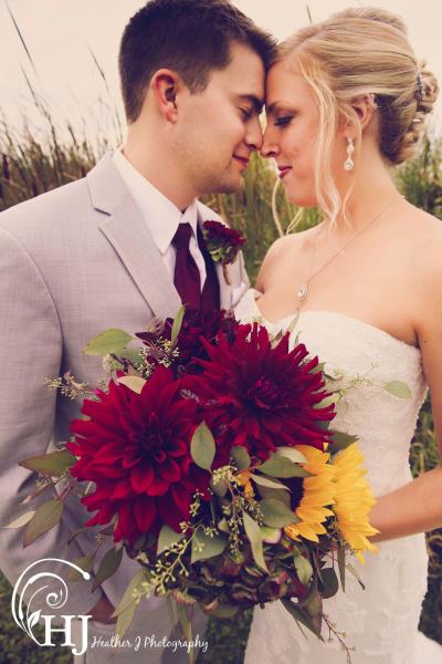 Beautiful fall wedding with locally grown deep red dahlias, sunflowers, antique hydrangea, sunflowers and seeded eucalyptus.