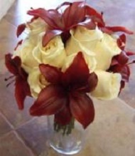 Ivory roses, dark red asiatic lilies.