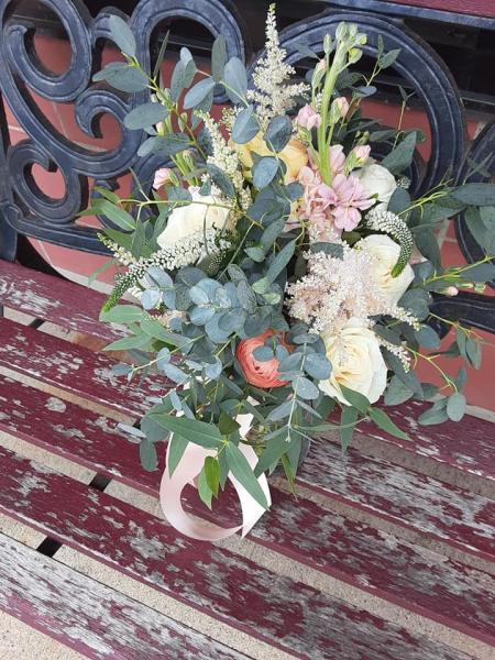  This bouquet was designed with peach ranunculus, ivory veronica, champagne roses, light pink astilbe and a variety of eucalyptus, very romantic!