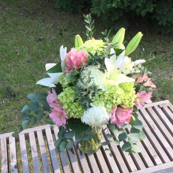 Lime green roses and mini hydrangea, white football mums and lilies, light pink alstromeria accented with eucalyptus.