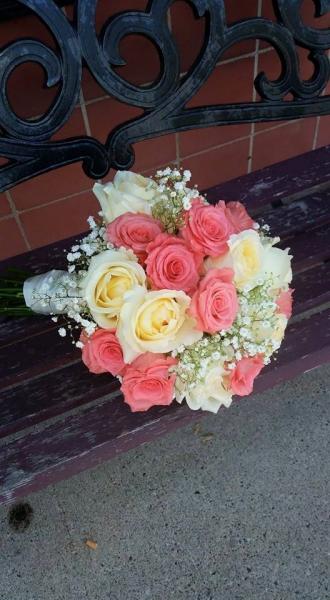  Salmon colored "movie star" rose, pale yellow roses and babies breath.