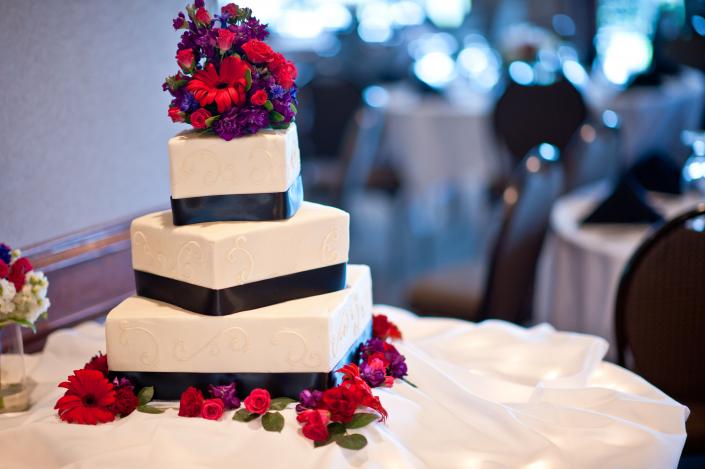 This square wedding cake with flowers is a lovely addition to traditional wedding receptions.