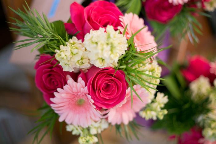 Bright pink roses, pale pink gerbera daisies, hydrangea and stock.