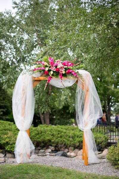 Pergola decorated at Courtyards of Andover, beautiful roses, gerbera daisies, gladiola and stock