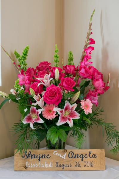 Stargazer lilies, roses, bells of Ireland, gerber daisies