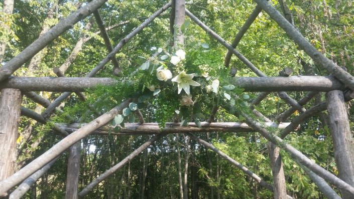 Rustic outdoor wedding at Bloom Barn in Shafer MN. Designed with lots of lush greenery, lilies and roses.