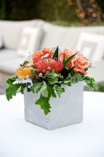 Rose roses, pin cushion protea designed in a concrete square contemporary vase.