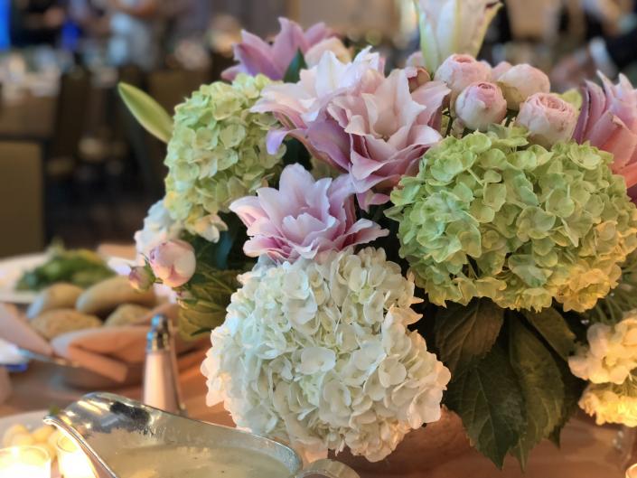 Lush hydrangea, double oriental lilies and ranunculus in shades of pinks and lime green.