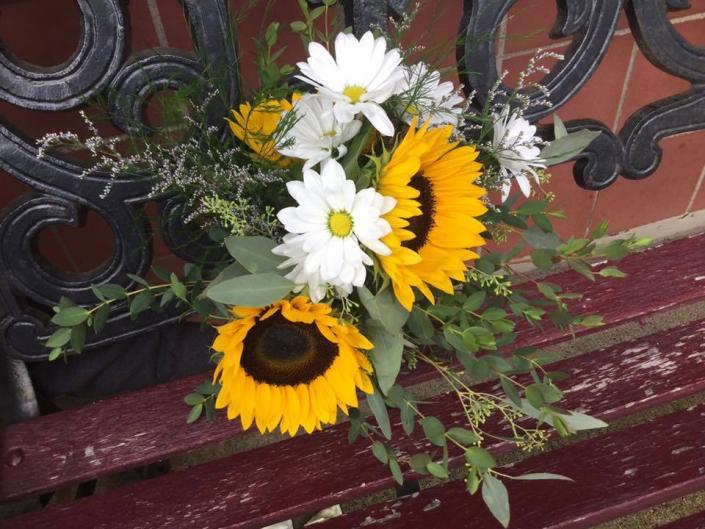  Wild flower bridal bouquwt with sunflowers and white daisies and a variety of greenery including eucalyptus.