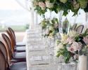 Beautiful, soft bouquets line this table with roses, hydrangea and lush greenery.