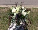 White ranunculus, roses, astilbe and lush green accents.