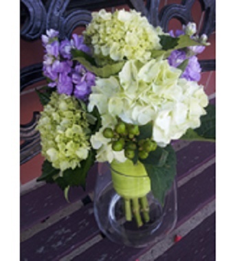 Lime green and white hydrangea, lavender stock and green hypericum berries.