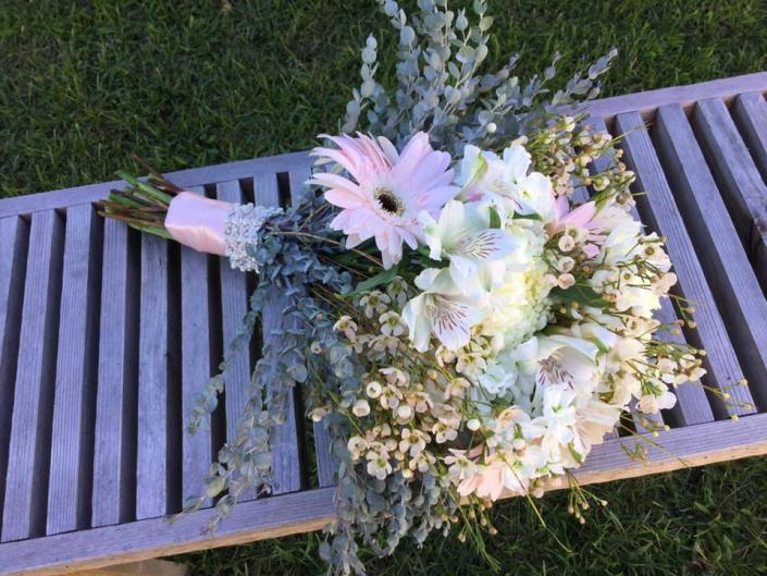 Designed with eucalyptus, gerbera daisies, alstromeria and waxflower.