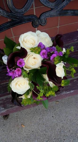 Dark purple minature calla lilies, ivory roses, bupleurum, fushia phlox.