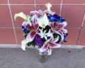 Miniature white calla lilies, bright blue and white dendrobium orchids, stargazer lilies, purple lisianthus.