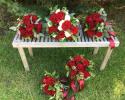 Bride and bridesmaids bouquets, deep red "heart" roses, white roses and a variety of greenery.
