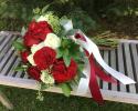 Deep red "heart" roses designed with white roses, seeded eucalyptus and israeli ruscus.