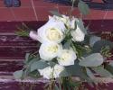 Large and mini fragrant white roses, a variety of eucalyptus and leatherleaf fern, tied off with champagne ribbon.