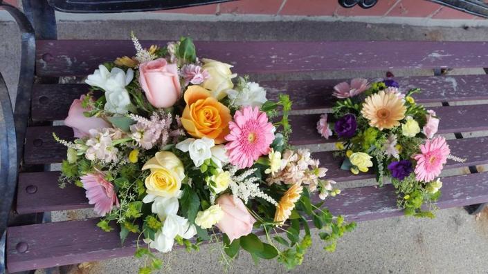 A cascading bouquet with gerber daisies, roses, freesia, astilbe, stock, phlox.....and a matching minature bouquet for the flower girl!