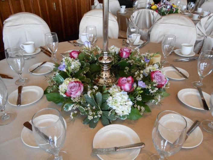 Lush wreaths designed with hydrangea, purple roses, freesia, waxflower and unique greenery.  (Tournament Players Club in Blaine MN)