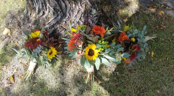 Sunflowers, gerbera daisies, mushrooms, hypericum berries, grevillia.