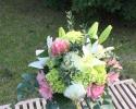 Lime green roses and mini hydrangea, white football mums and lilies, light pink alstromeria accented with eucalyptus.