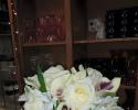 White calla lilies with purple inside, white alstromeria, roses.