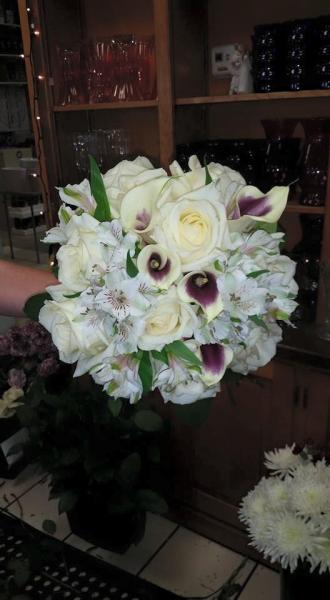 White calla lilies with purple inside, white alstromeria, roses.