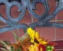  Rust sunflowers, tinted solidago, fall mums and green hypericum berries.