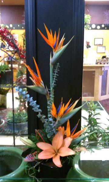 Perfect for a tropical event or island theme. Bird of paradise and orange asiatic lilies.